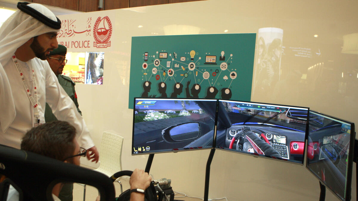 A visitor tries out a virtual car game which enables users to drive a car in different climates. 