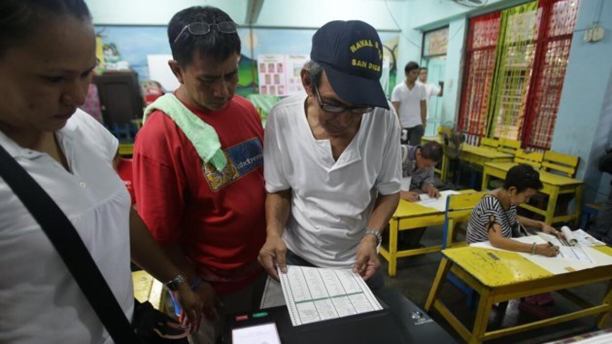 Brass band & banners: Philippine candidates register for mid-term poll