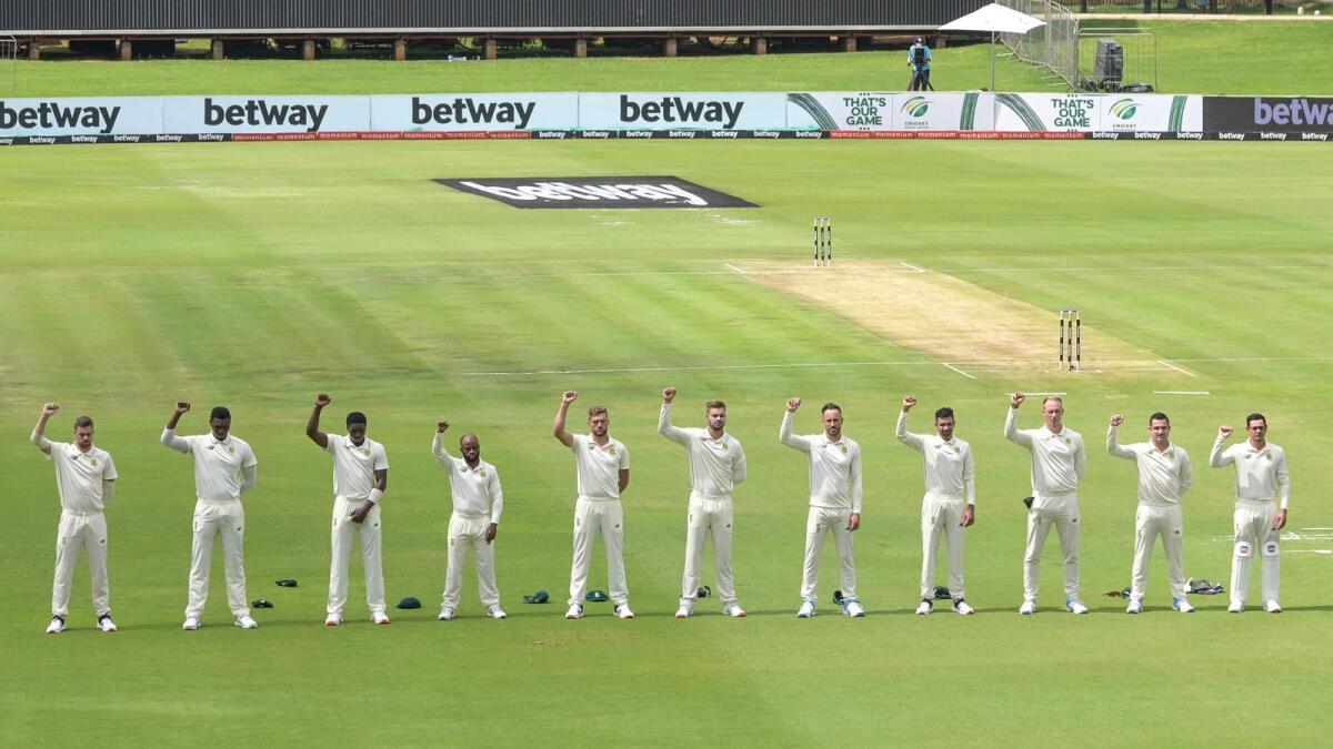 South African cricket players raise their fists in the air in solidarity with the Black Lives Matter (BLM) movement during the opening day of the first Test against Sri Lanka. — AFP