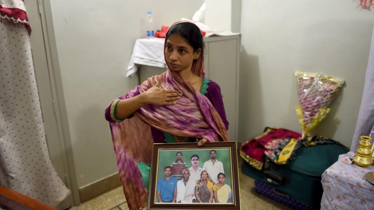 Geeta holds a photograph of a family in India which she believes is her family, during an AFP interview at the EDHI Foundation in Karachi.   