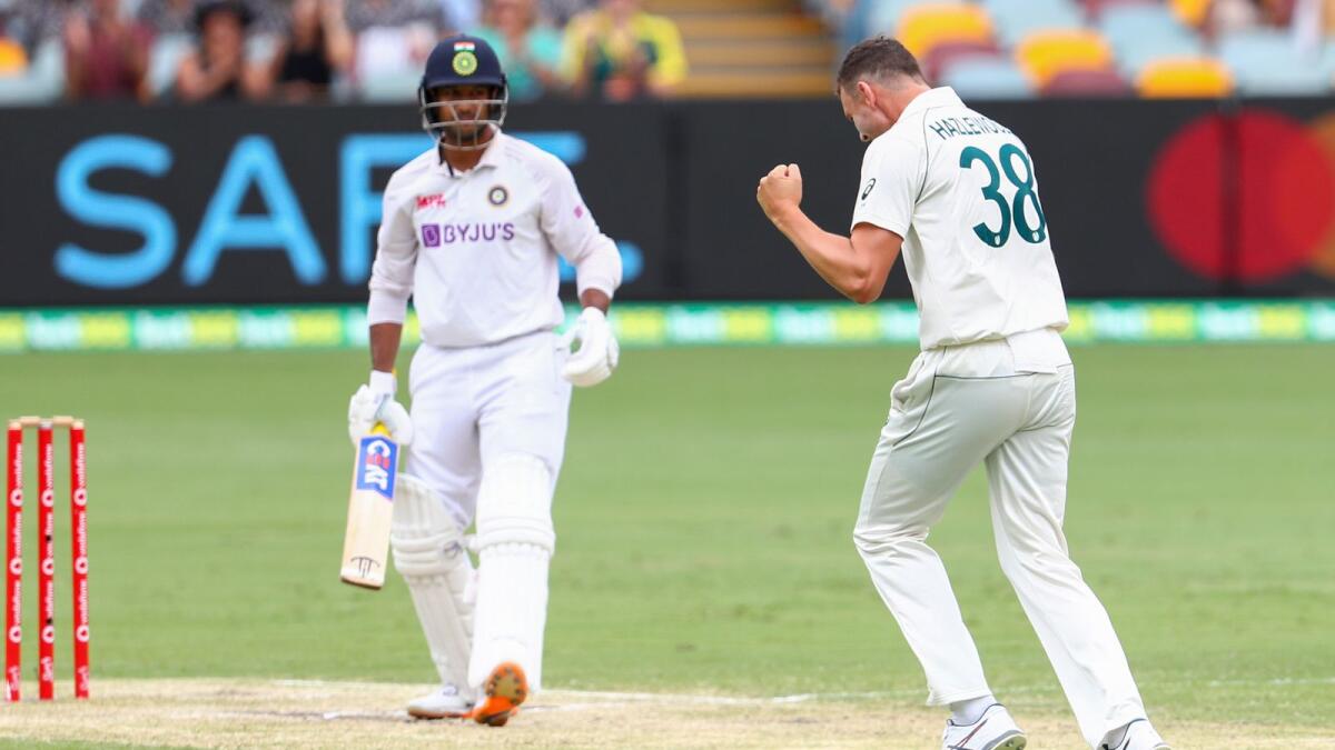 Australia's Josh Hazlewood celebrates after dismissing India's Mayank Agarwal. — AP