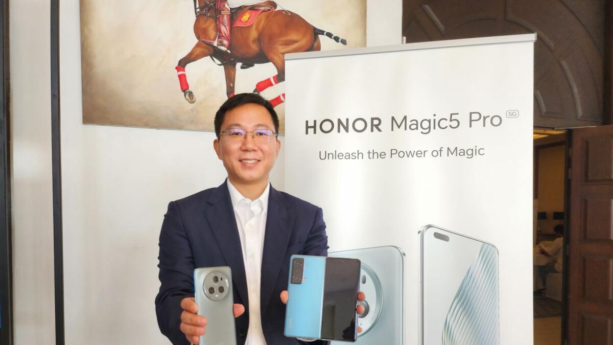 Mafeijian, country manager of Honor in the GCC region, poses with the Magic5 Pro and foldable Magic Vs. — Supplied photo