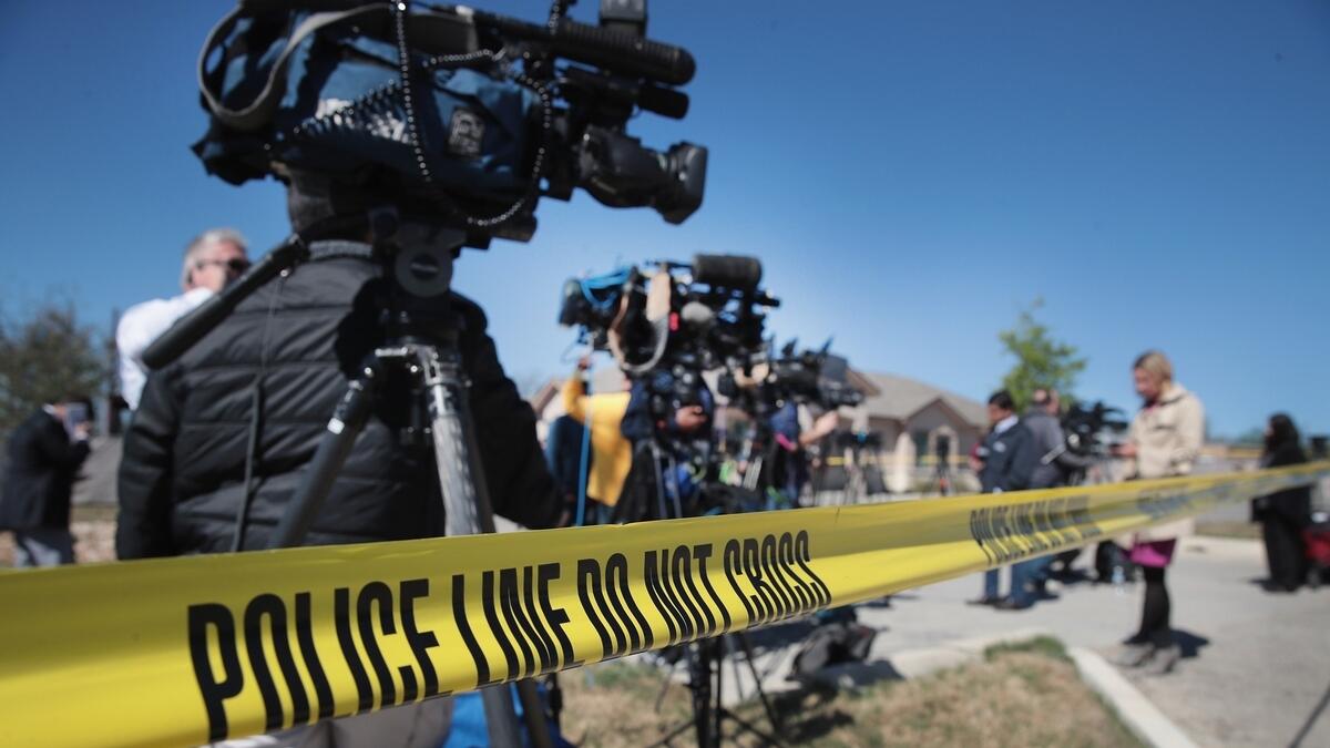 News media report from outside a FedEx facility following an explosion in Schertz, Texas.-AFP