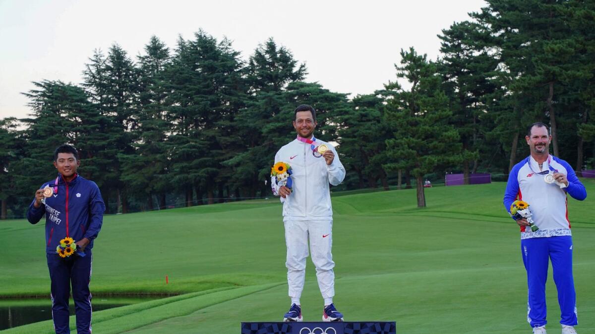 (Left to right): Bronze medallist Taiwan's Pan C T, gold medallist USA's Xander Schauffele and silver medallist Slovakia's Rory Sabbatini stand on the podium at the medal ceremony of the men's golf individual stroke play during the Tokyo 2020 Olympic Games. — AFP