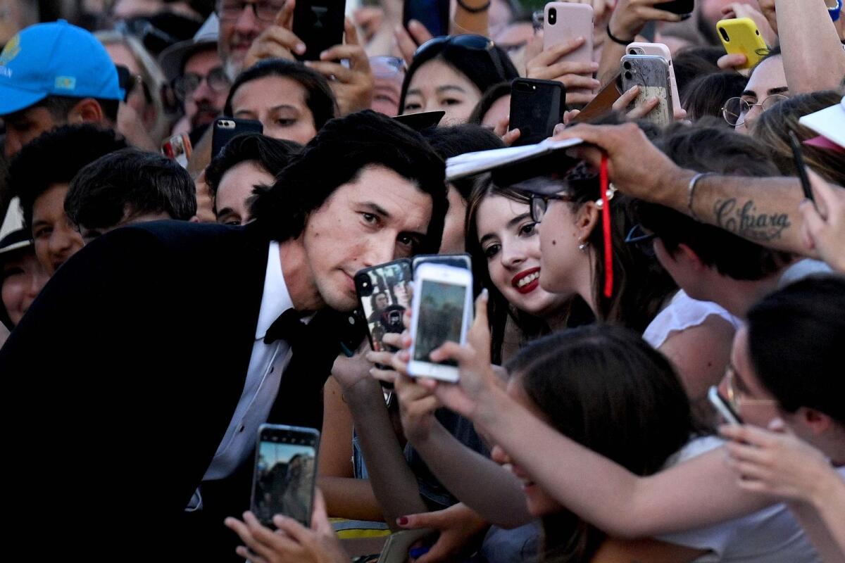 Adam Driver poses for selfie photos at the Opening Ceremony and the screening of the film 'White Noise' during the 79th Venice International Film Festival at Lido di Venezia in Venice, Italy.