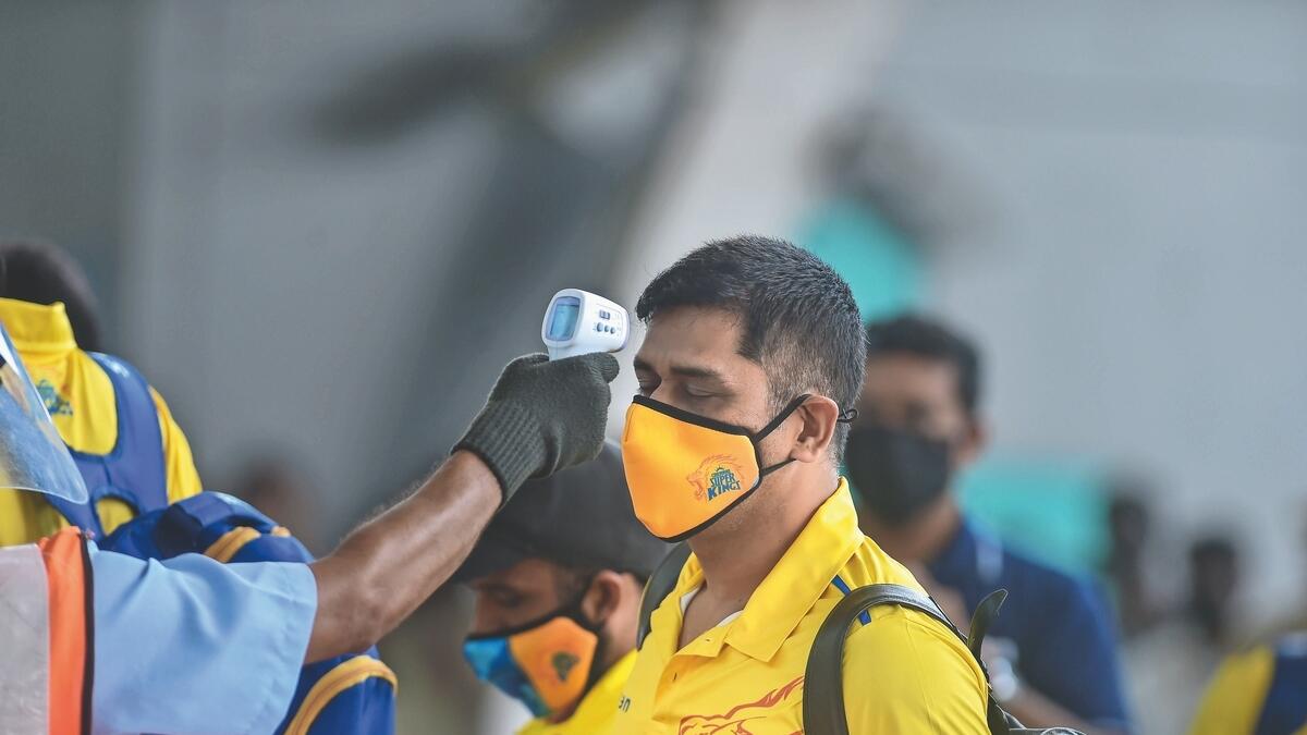 Chennai Super Kings skipper MS Dhoni undergoes thermal screening at the Chennai airport before leaving for the UAE on Friday. - PTI