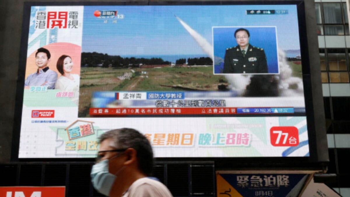 A TV screen shows that China's People's Liberation Army has begun military exercises, including live firing in the waters and airspace near Taiwan. — Reuters