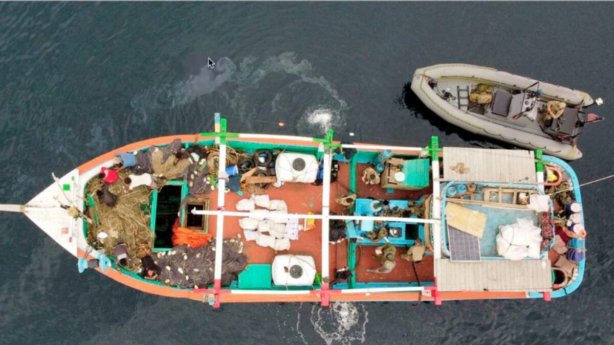 In this aerial photo released by the US Navy, US service members from coastal patrol ship USS Tempest (PC 2) and USS Typhoon (PC 5) inventory an illicit shipment of drugs while aboard a stateless dhow vessel transiting international waters in the Arabian Sea. — AP