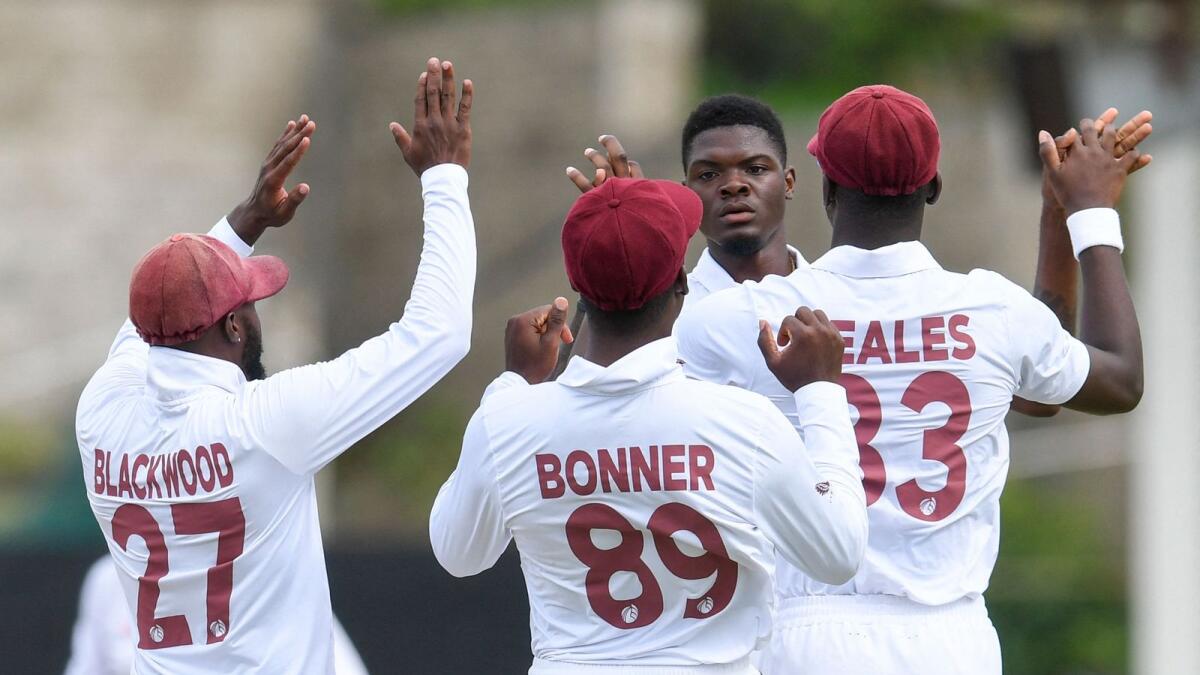 West Indies players celebrate a wicket. (AFP)