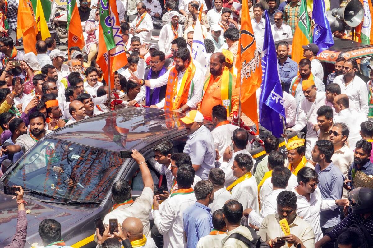 BJP candidate for upcoming Lok Sabha elections from Pune Murlidhar Mohol waves at supporters during election campaign in Pune on Thursday. — PTI