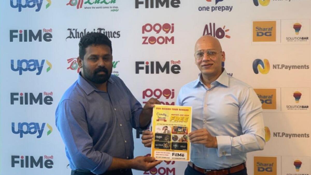 Faisal Mushtaq, promoter and distributor of FilMe in the GCC, gives a voucher to customer Babu Kochanian Perumbully on achieving the 1 millionth usage.