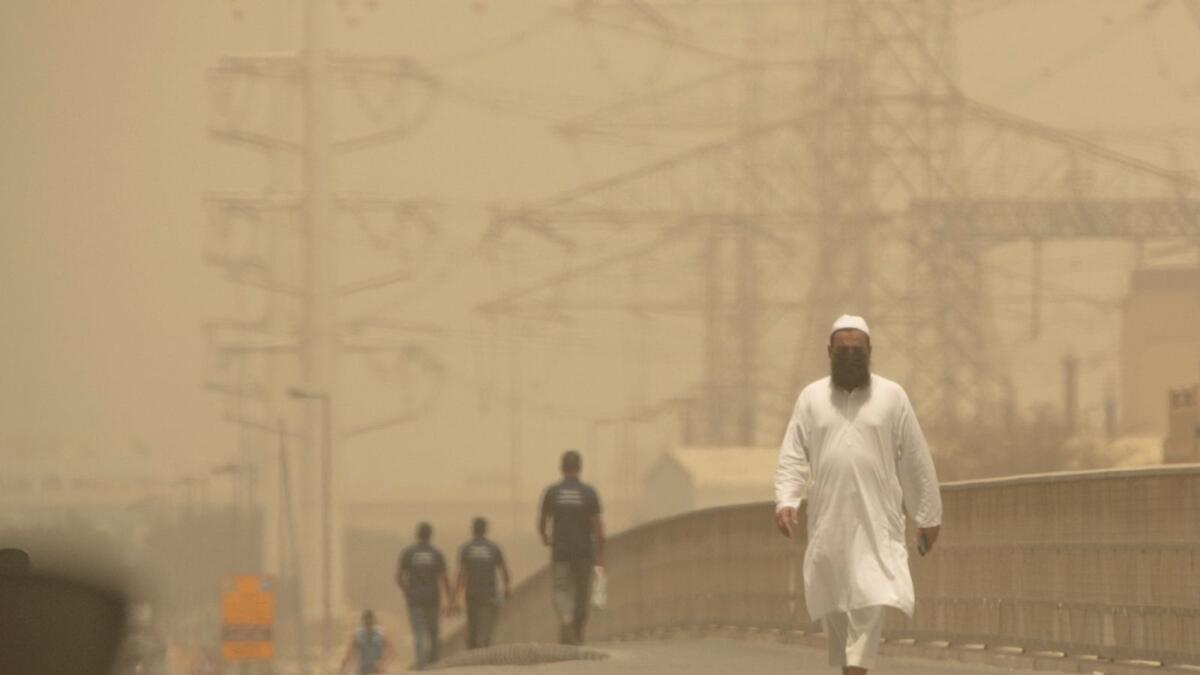 Residents walk in the sandstorm in Sharjah on Wednesday, May 18, 2022. Photo by Shihab