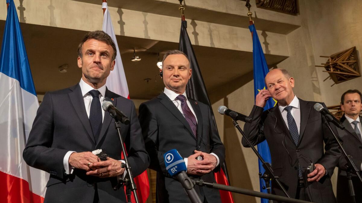 From left, French President Emmanuel Macron, Polish President Andrzej Duda and German Chancellor Olaf Scholz (SPD) make a joint press statement on the sidelines of the Security Conference in Munich, on Feb. 17, 2023. — AP