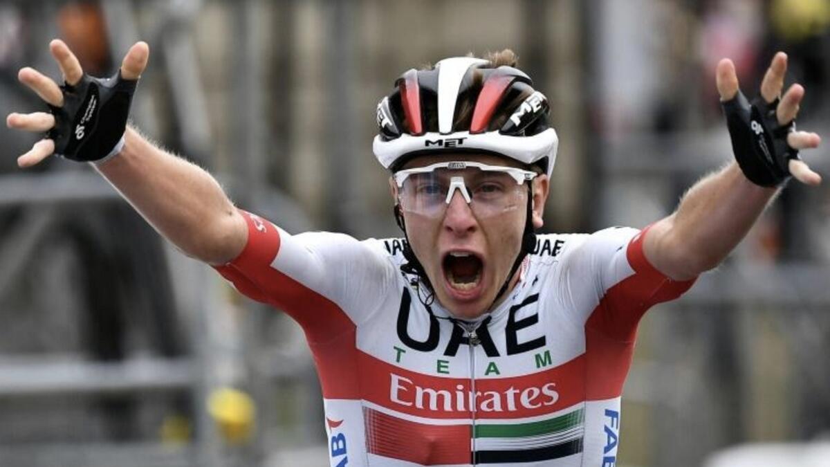 UAE Team Emirates' rider Tadej Pogacar celebrates as he crosses the finish line at the end of the 9th stage of the Tour de France. - AFP