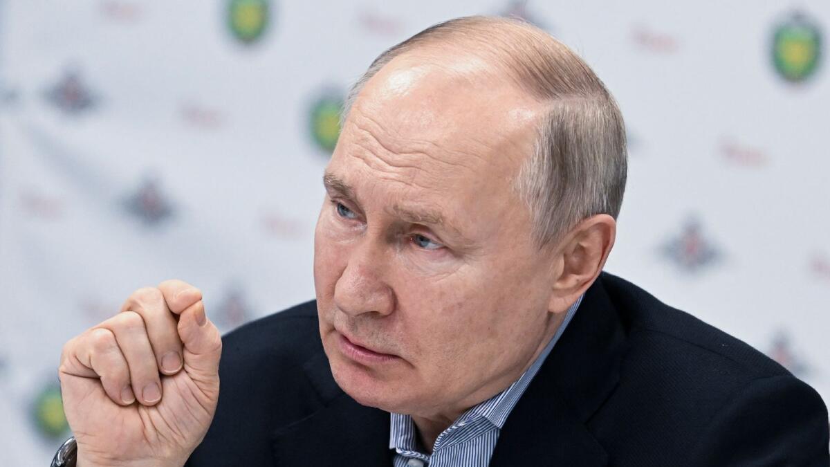 Russian President Vladimir Putin speaks to Russian servicemen undergoing treatment on January 1. — AP