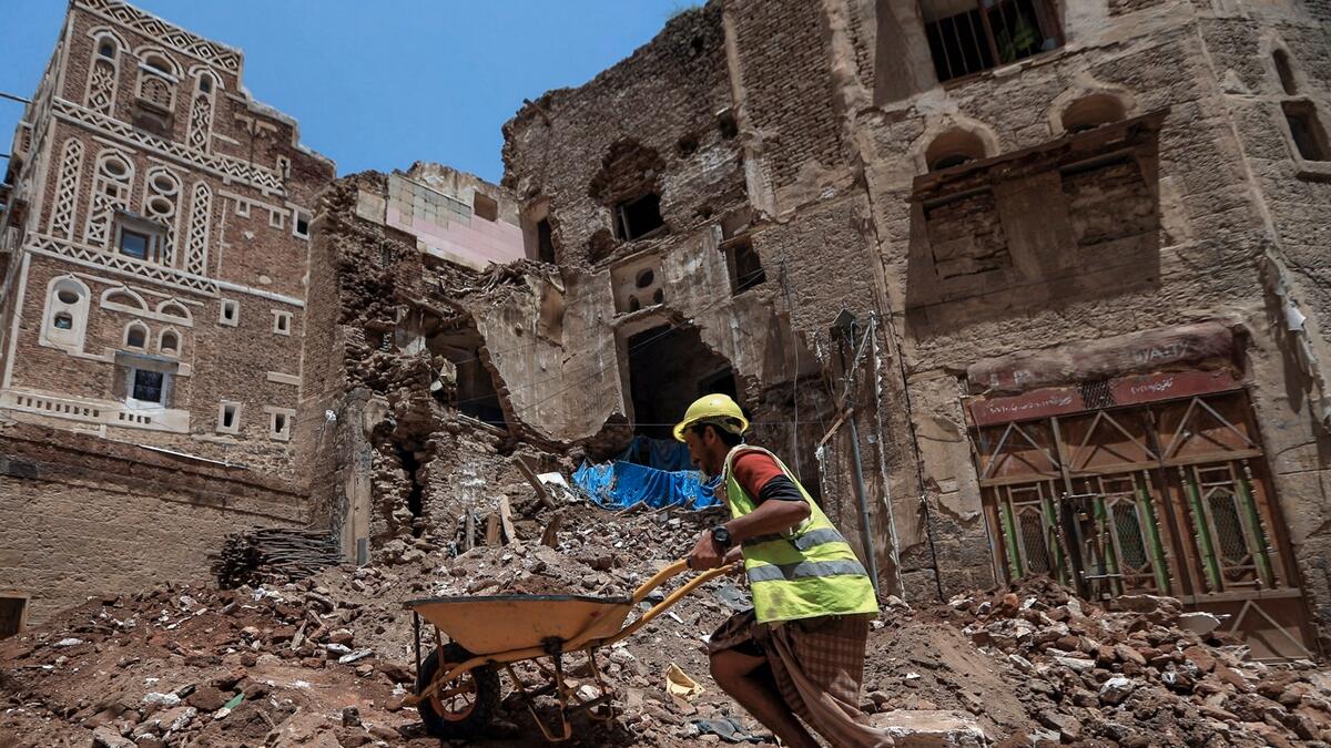 Yemeni labourers remove the rubble ahead of restoration works on the site of a collapsed UNESCO-listed building following heavy rains, in the old city of the Yemeni capital Sanaa. Flash floods triggered by torrential rains have killed at least 172 people across Yemen over the past month, damaging homes and Unesco-listed world heritage sites, officials said. Photo: AFP