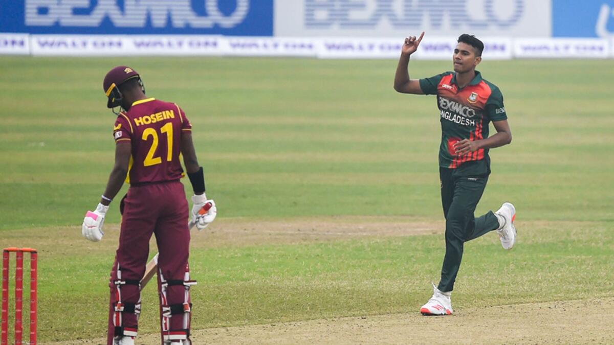 Bangladesh's Hasan Mahmud (right) celebrates dismissing West Indies' Akeal Hosein during the first ODI cricket match at the Sher-e-Bangla National Cricket Stadium in Dhaka. — AFP