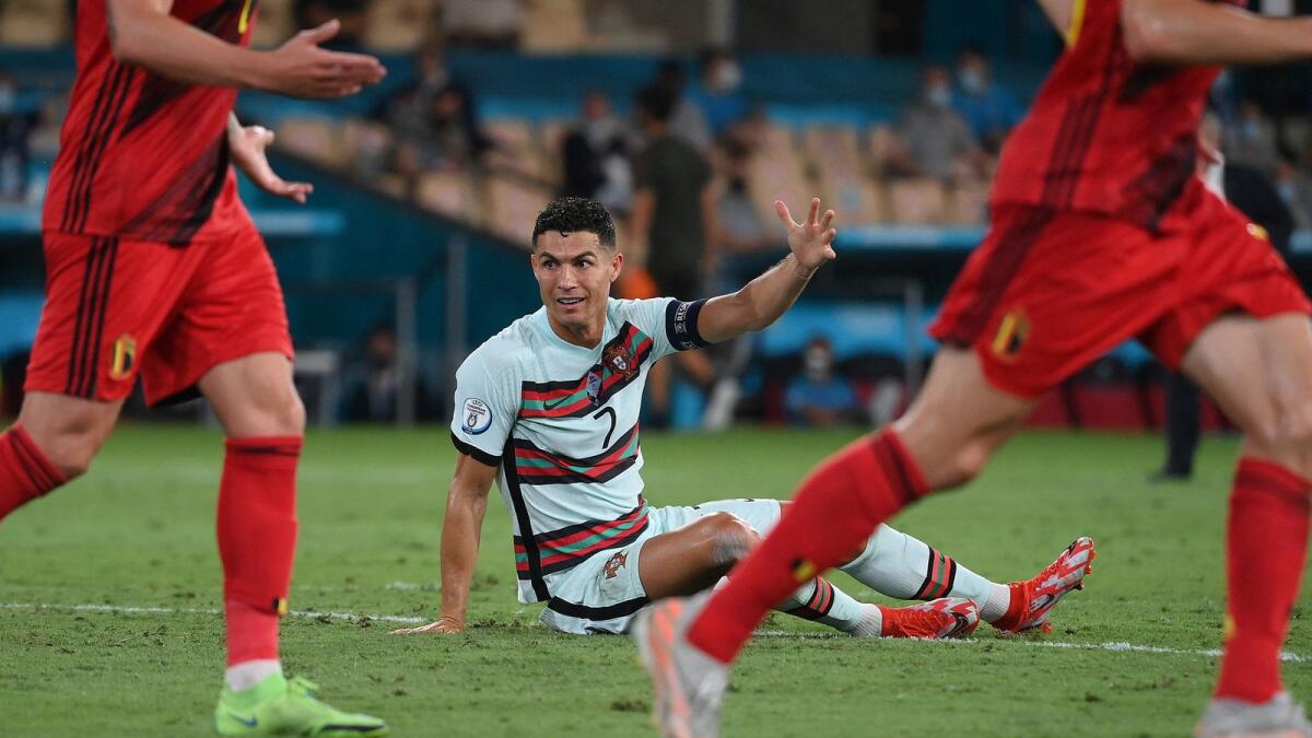 Portugal striker Cristiano Ronaldo reacts after being fouled during the match against Belgium. (AFP)
