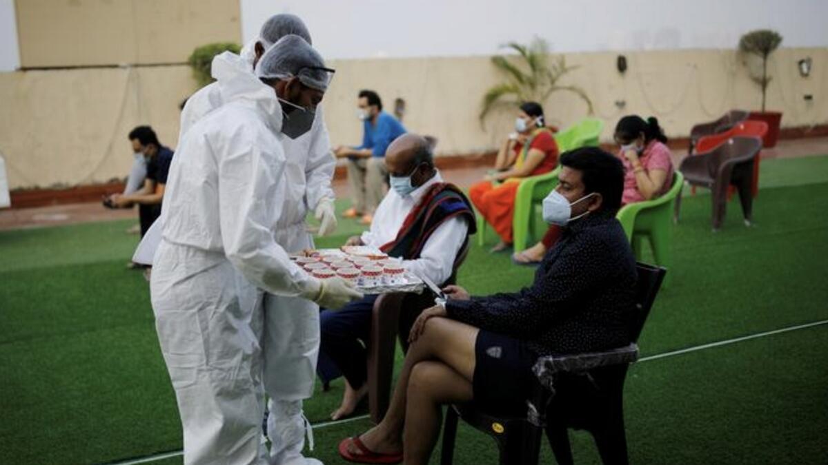 Hospital staff serves tea to a patient suffering from the coronavirus during an evening buffet at a terrace of the Yatharth Hospital in Noida, on the outskirts of New Delhi, India.