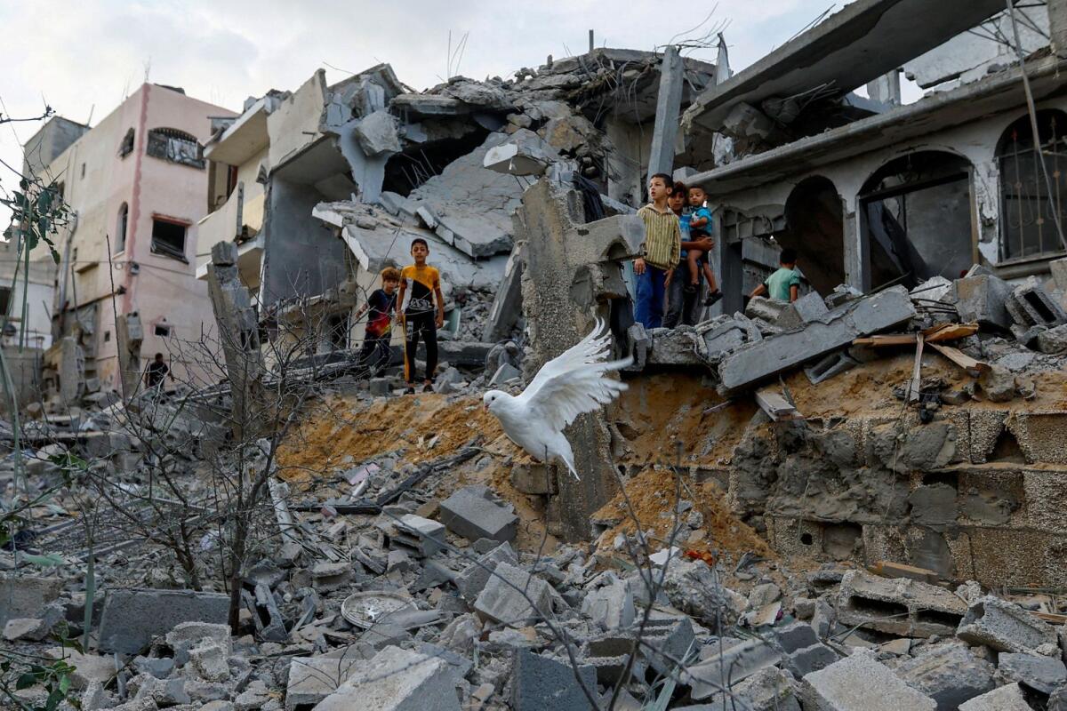 A dove flies over the debris of houses destroyed in Israeli strikes in Khan Younis in the Gaza Strip. — Reuters