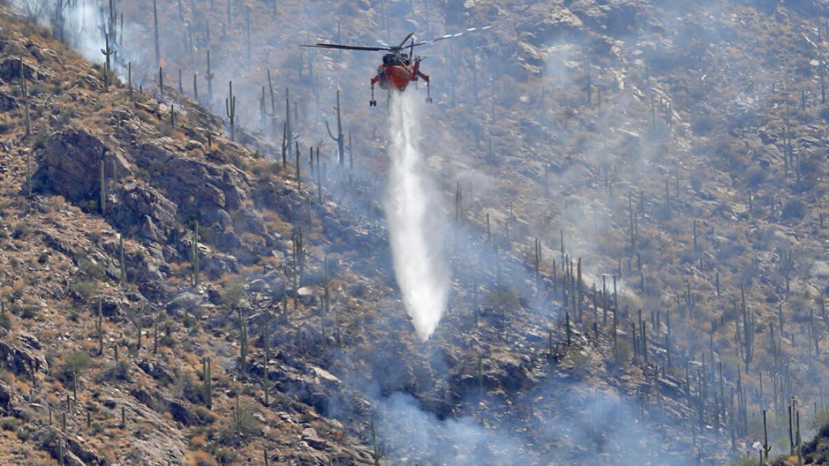 A Wildfire air attack crew battles the Bighorn Fire along the western side of the Santa Catalina Mountains, Friday, June 12, 2020, in Tucson, Ariz. Photo: AP