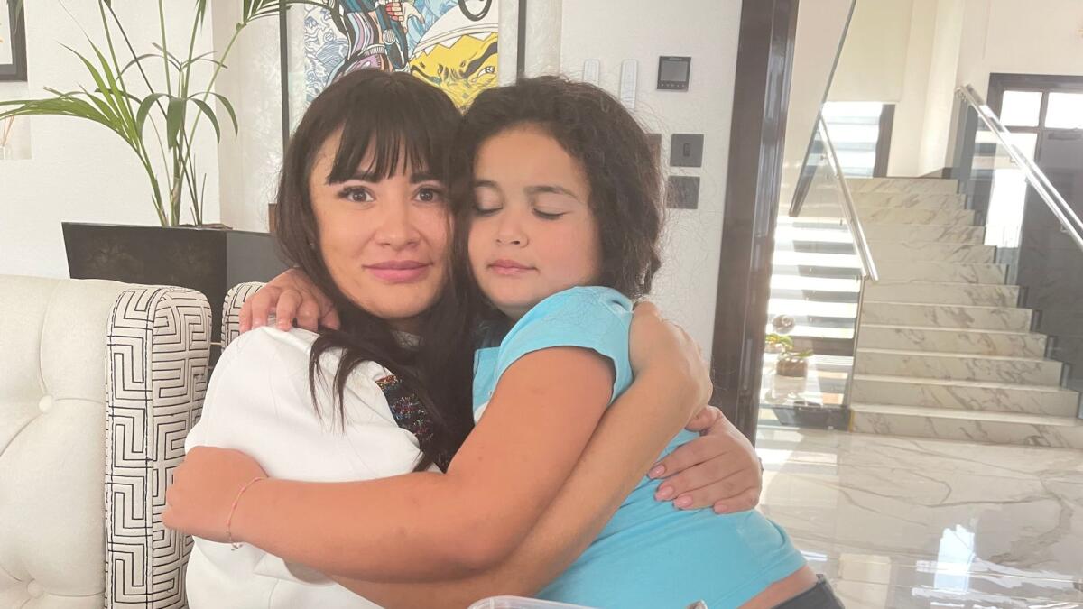 Happy reunion as Sofia Shamuzzi hugs her daughter after escaping from Ukraine where she had gone for a business trip