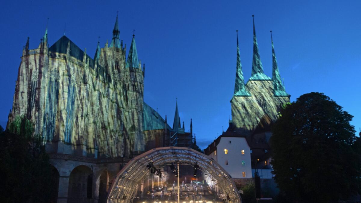 Singers and orchestra musicians perform during the rehearsal of the Cathedral Steps open air festival (Domstufen-Festspiele) in front of the Mariendom (Cathedral of Mary) and the St. Severi's Church in Erfurt, Germany. Photo: AP