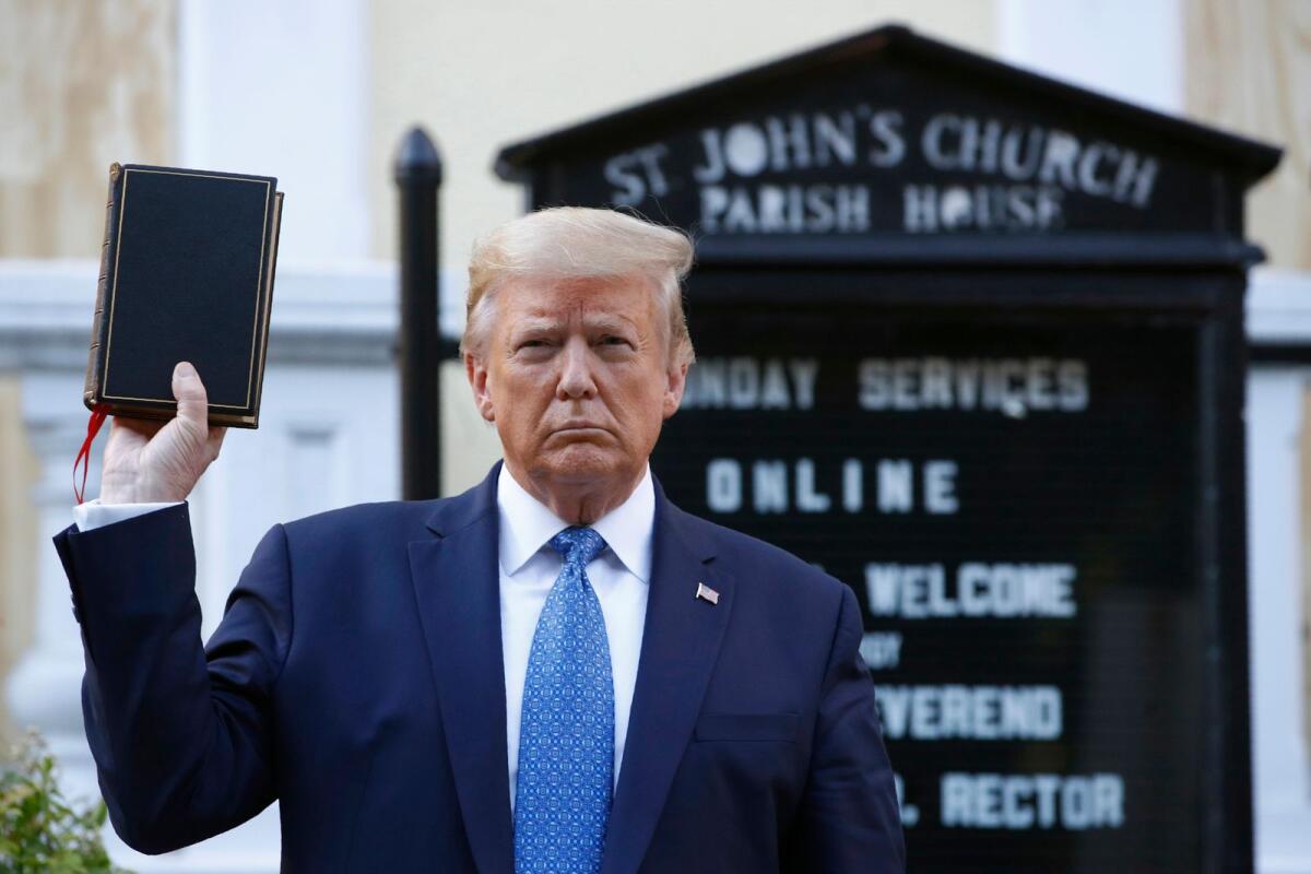Donald Trump holds a Bible as he visits outside St. John's Church across Lafayette Park from the White House on June 1, 2020, in Washington.  — AP file