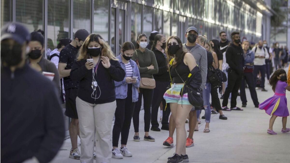 People stand in a line at a Covid-19 testing site set up at the Miami Beach, Florida. — AFP