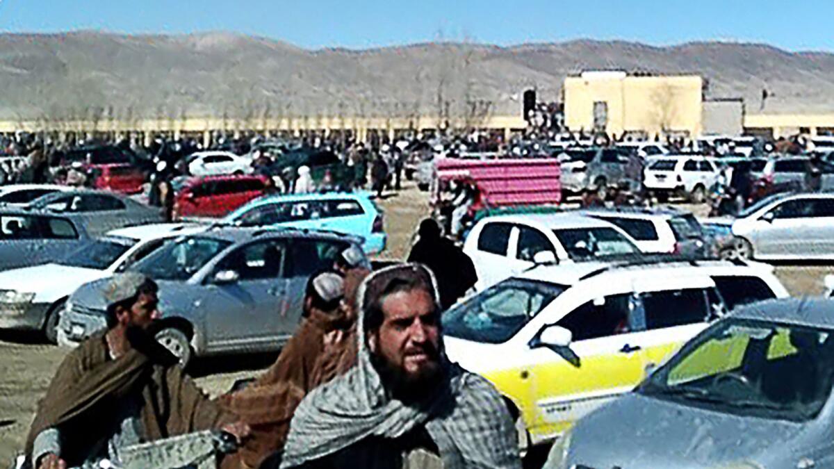 This screen grab from a video shows Afghan men leaving a football stadium after attending the public execution by Taliban authorities of two men convicted of murder, in Ghazni. — AFP