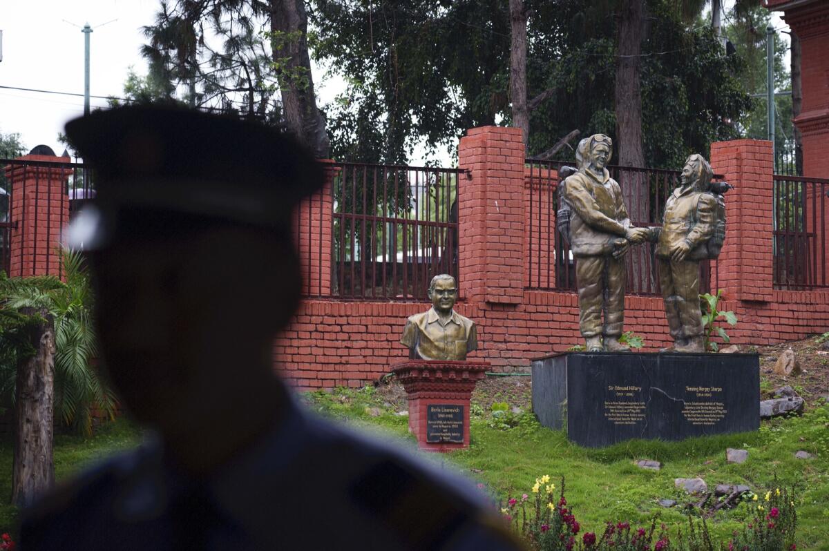 A security person stands guard in front of a statue of Tenzing Norgay and Edmund Hillary at the tourism board in Kathmandu, Nepal, on May 25, 2023. Photo: AP