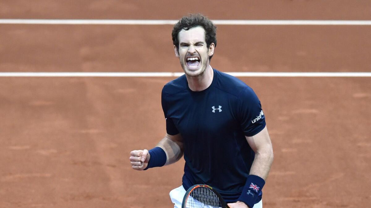 Britain's Andy Murray celebrates after winning his singles match against Belgium's Ruben Bemelmans on the first day of the Davis Cup final on Friday. — AFP