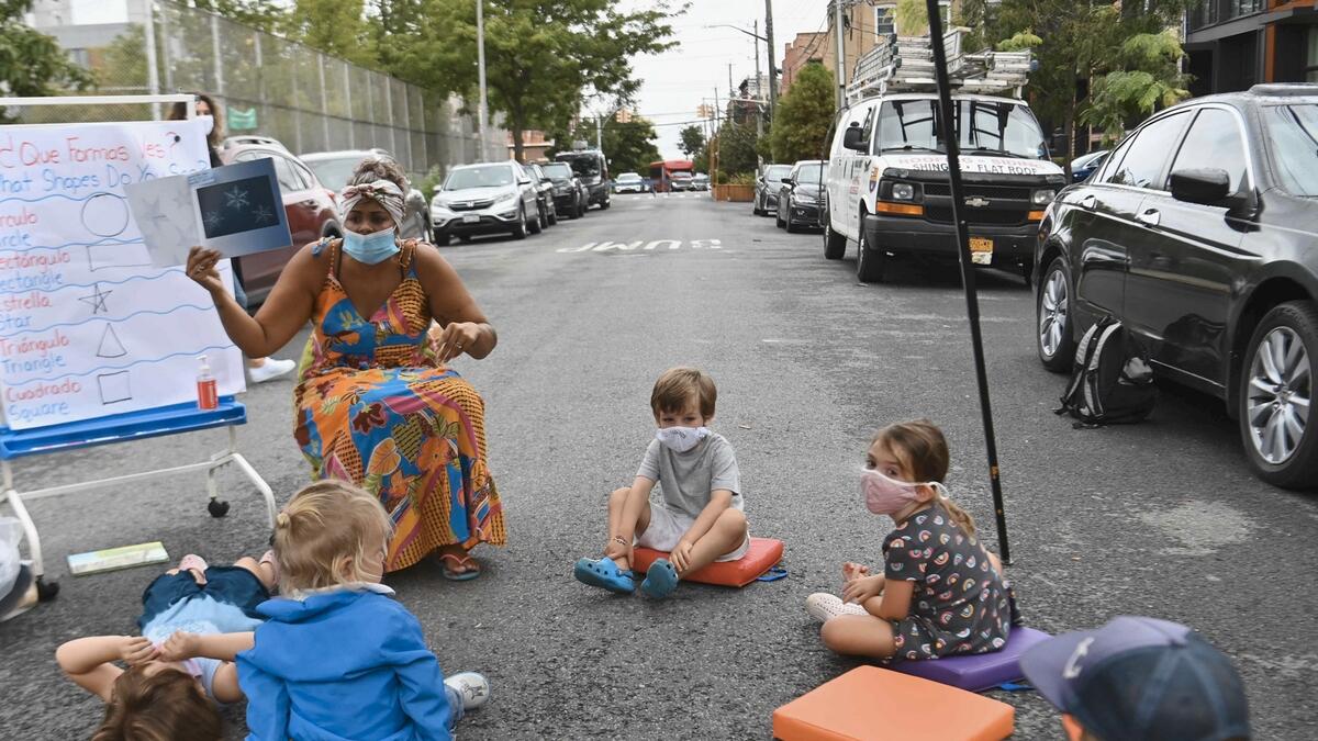 A teacher conducts a lesson with students during an outdoor learning demonstration for New York City schools in front of the Patrick F. Daly public school (P.S. 15) in the Brooklyn borough of New York City. Photo: AFP