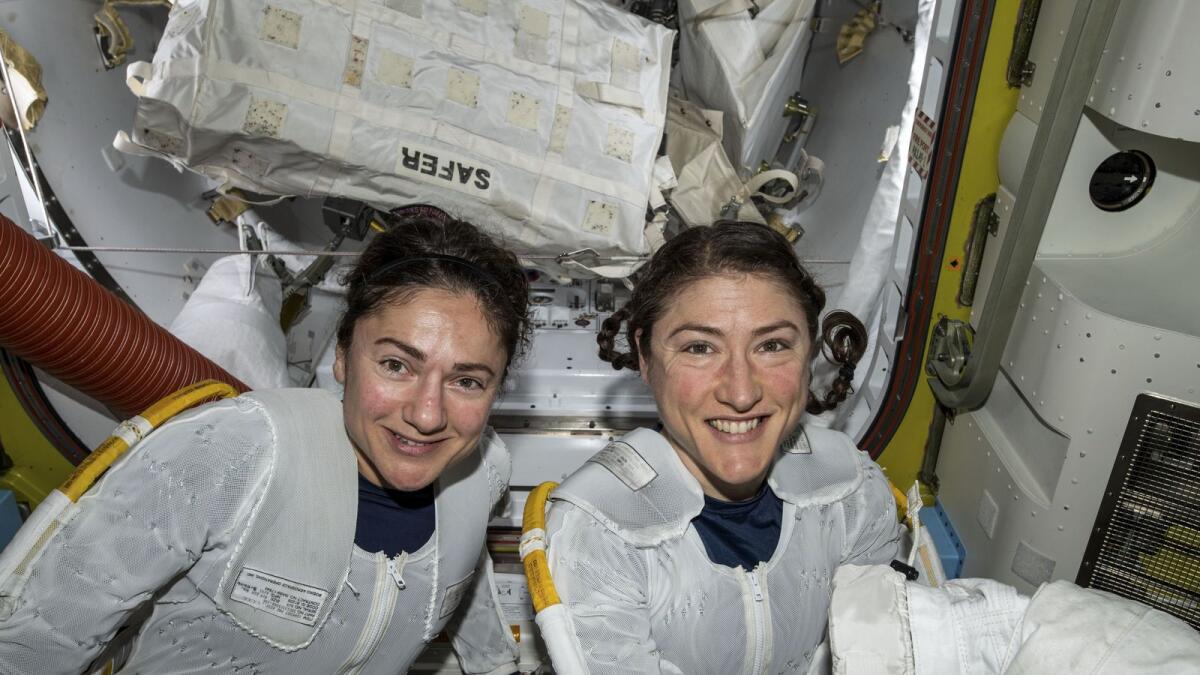 Jessica Meir (L) and Christina Koch (R) putting on their spacesuits as they prepare to leave the hatch of the International Space Station and begin the historical first-ever all-female spacewalk on October 18, 2019. — AFP file