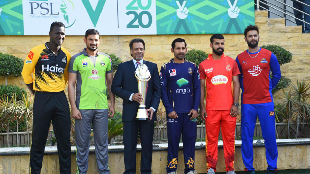 Pakistan's former squash world champion Jahangir Khan holds the PSL trophy along with captains of five participating teams, Darren Sammy, Sohail Akhtar, Sarfaraz Ahmed, Shadab Khan and Imad Wasim at the National Stadium in Karachi. - AP