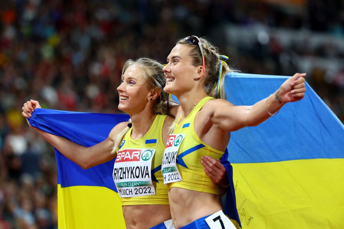 Ukraine's Viktoriya Tkachuk celebrates her second-place finish in the women's 400m hurdles final at the 2022 European Championships alongside her compatriot Anna Ryzhykova who finished third. — Reuters