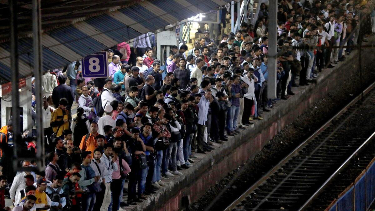 Commuters crowd on a platform as they wait to board suburban trains at a railway station in Mumbai, India. - Reuters file
