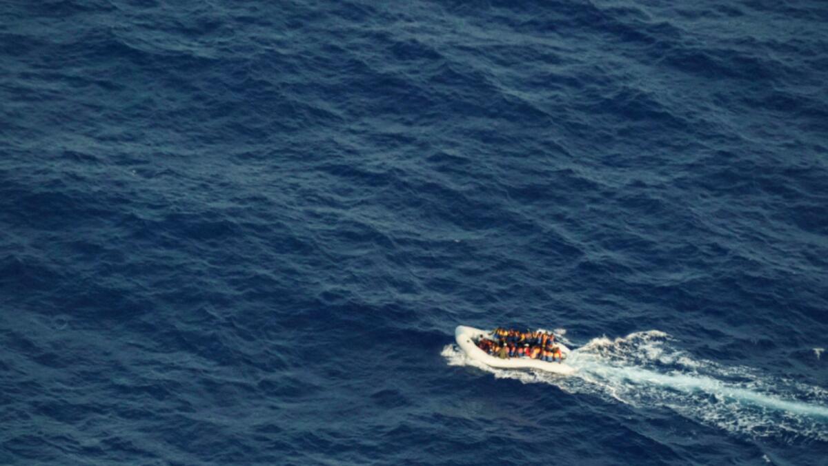 Migrants on an overcrowded rubber boat flee Libya. — AP file