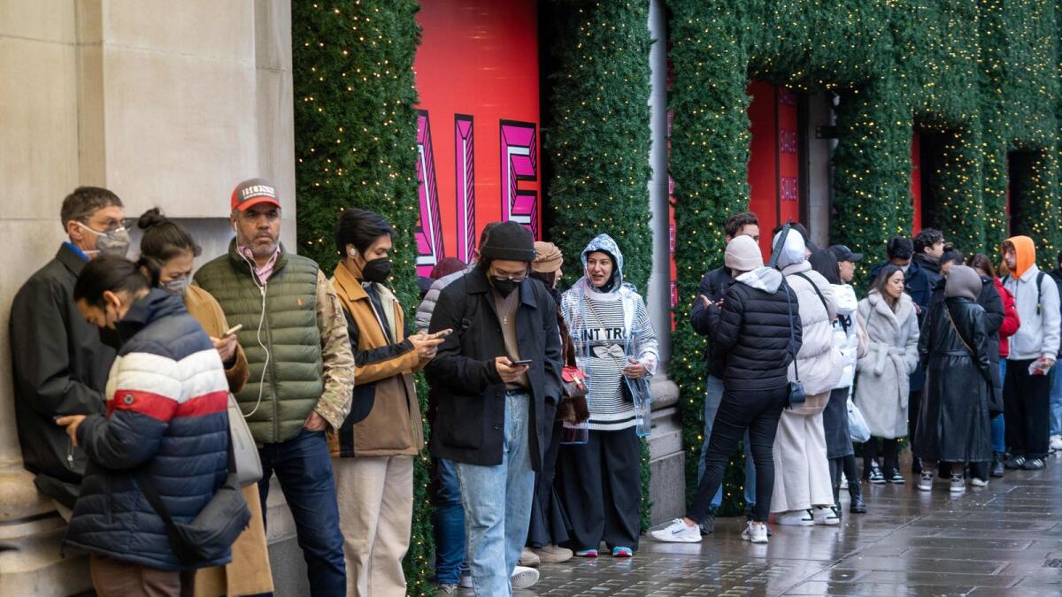 Shoppers queue to enter Selfridges department store ahead of the Boxing Day sale in  London. – AFP