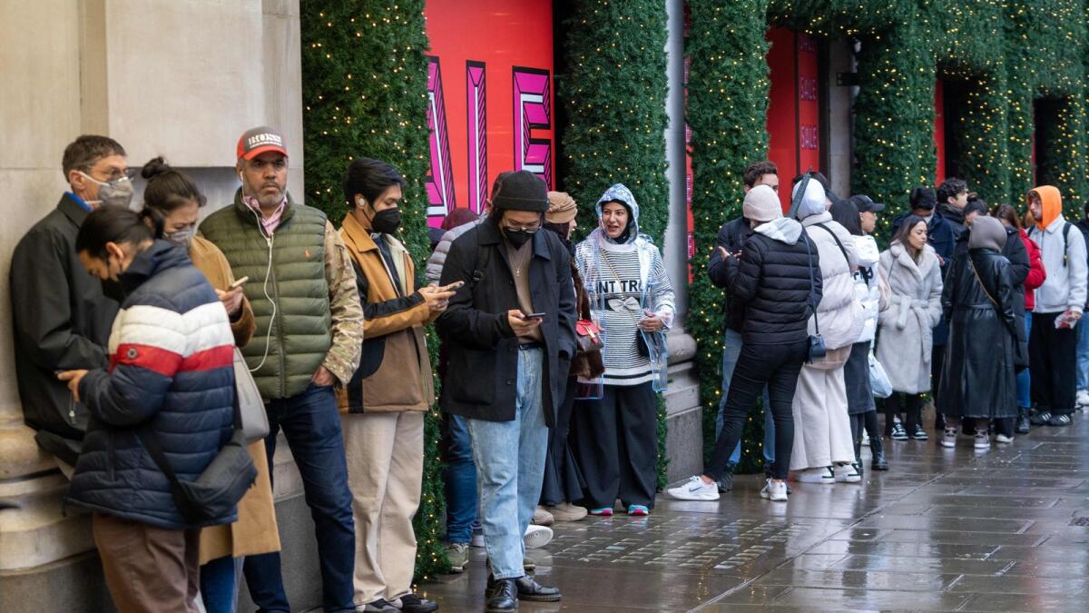 Shoppers queue to enter Selfridges department store ahead of the Boxing Day sale in  London. – AFP