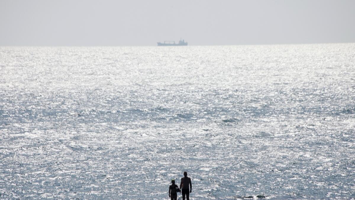 People enjoy the sun at the beach in the Black Sea in Odessa, Ukraine. Photo: AP