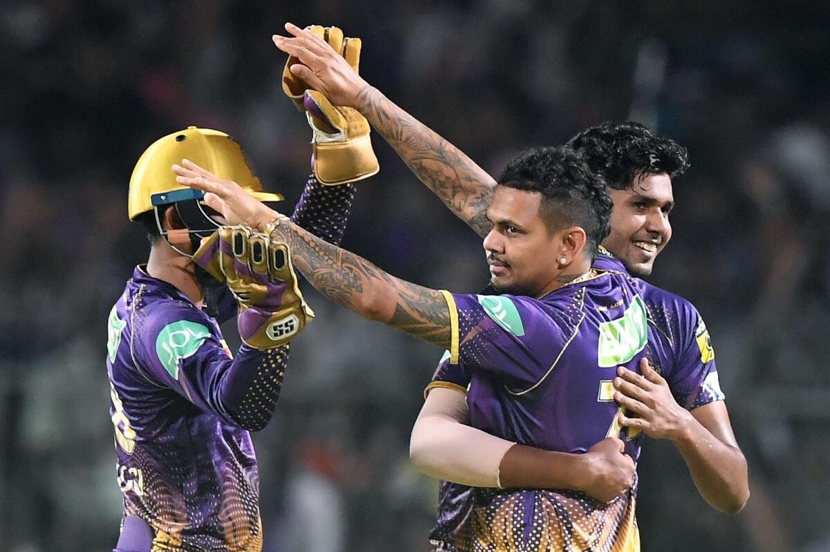 Kolkata Knight Riders' Sunil Narine (centre) celebrates with teammates after taking a wicket. — AFP