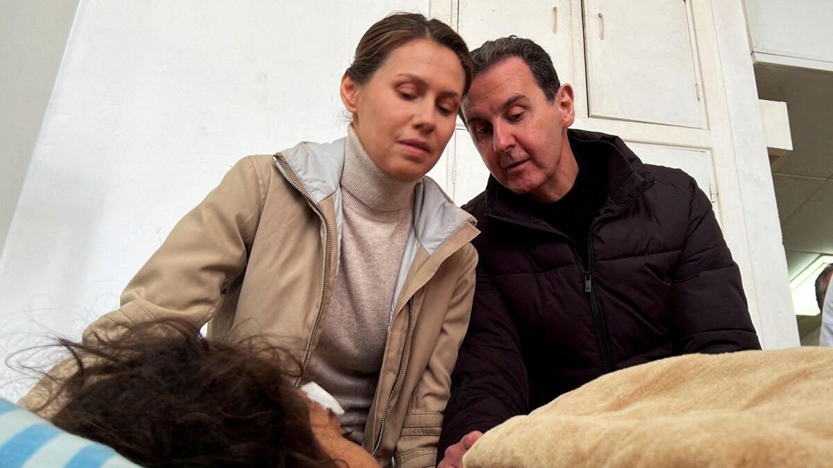 Syrian President Bashar Al Assad and his wife Asma visit an injured girl who survived the earthquake. — Reuters file