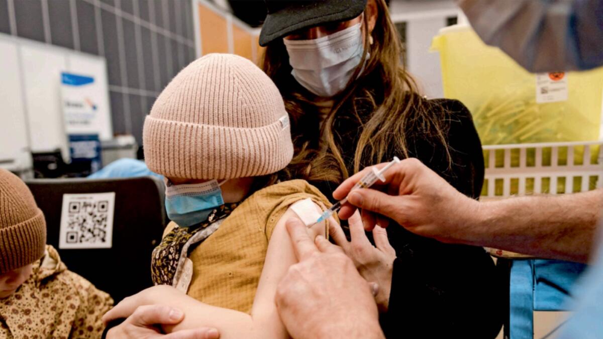 A child, age 7, receives the Pfizer-BioNTech Covid-19 vaccine for children in Montreal. — AFP