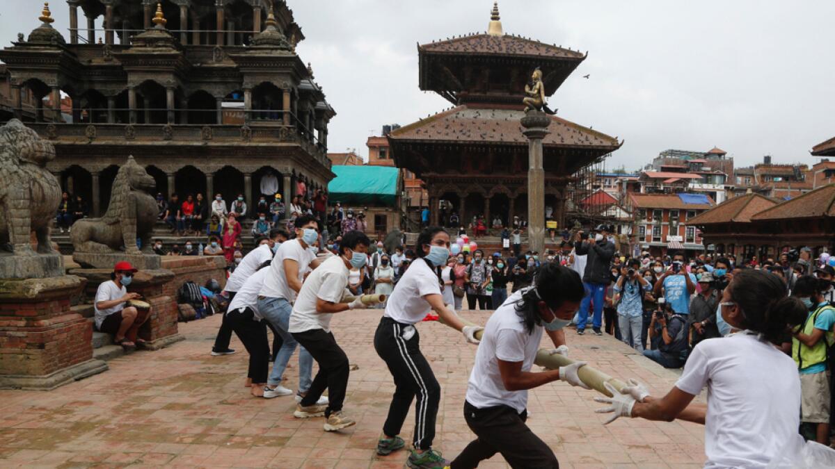 Nepalese youth perform a play as a part of a protest demanding better Covid-19 management at Patan Durbar Square near Kathmandu, Nepal. Hundreds of Nepalese gathered Tuesday protesting against government's alleged failure to increase testing for coronavirus and overall handling of the pandemic. Photo: AP