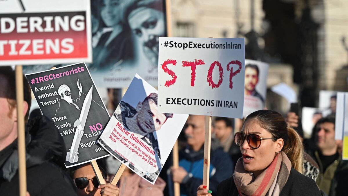 Protesters hold placards at a march in central London on Saturday against the Islamic Revolutionary Guard Corps (IRGC), as protests against the Iranian regime continue.   — AFP