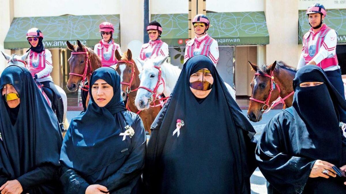 Citizens pose with volunteers of Pink Caravan Ride in Dibba on Thursday. The ride continued to carry out free breast cancer screenings and spread awareness messages. 