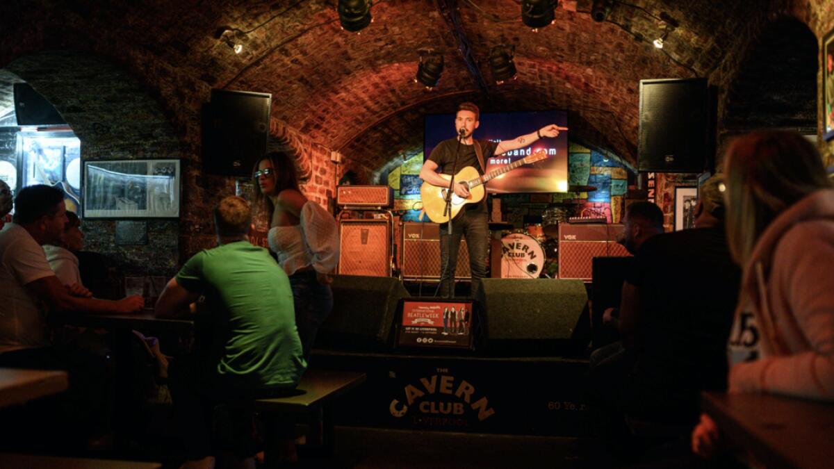 Musician Paul Jones plays Beatles songs to the audience in the Cavern Club as it reopens to the public with live music to host their annual 'Beatleweek' celebration of music by The Beatles in Liverpool, north west England.  The renowned underground live music venue first opened in 1957 and was instrumental in forging their early careers of several major bands including The Beatles who performed there on 292 occasions. Photo: AFP