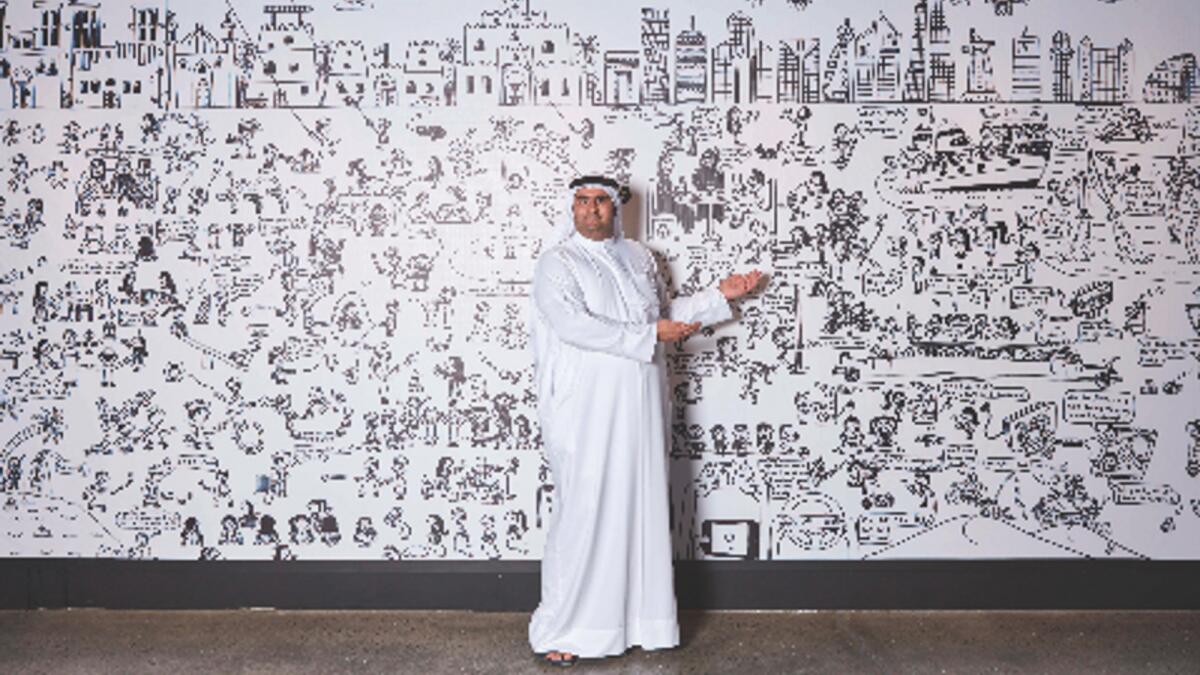 Artist Abdulla Lutfi with life-size mural