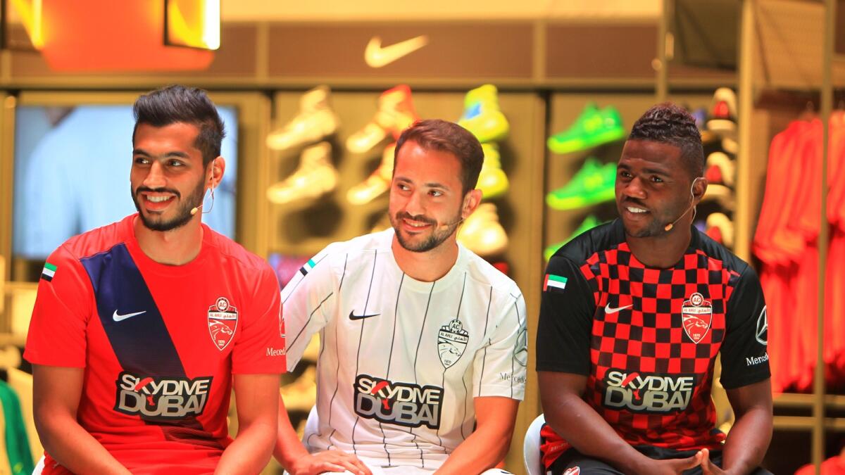 Al Ahli’s Majed Hassan, Everton Ribeiro and Ismail Al Hammadi at the unveiling of the team kit for the forthcoming seasonat Sun and  Sand Sports Store in Dubai Mall on Sunday. — Photo by Neeraj Murali